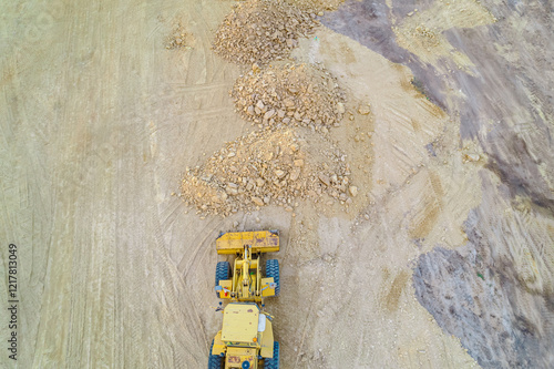 zenithal photograph of a bulldozer at a construction site, aerial top view with drone
