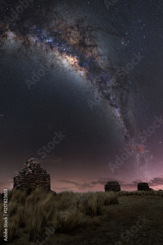 Inca chullpas at sunset with a sky full of stars and the center of the Milky Way in the Andes mountain range