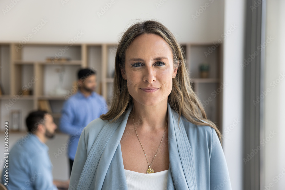 Head shot portrait of middle-aged businesslady dressed in casual clothes standing in office, gaze at camera, looking satisfied with position in company, promotion and professional achievements. Career Head shot portrait of middle-aged businesslady dressed in casual clothes standing in office, gaze at camera, looking satisfied with position in company, promotion and professional achievements. Career