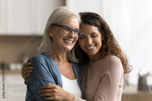 Fényképezés Portrait affectionate caring young woman grown up child daughter hold in arms hu