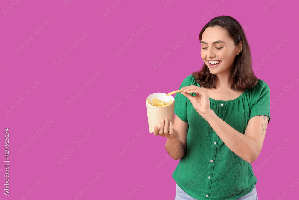 Happy young woman with french fries on purple background Happy young woman with french fries on purple background