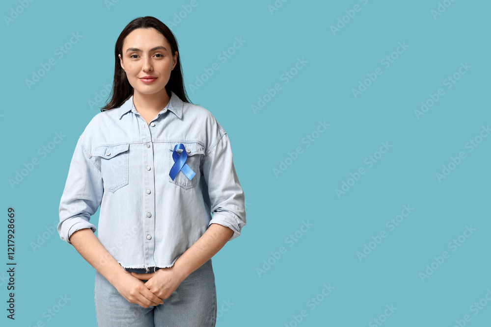 Pretty young woman with blue ribbon on color background. Colon cancer awareness concept Pretty young woman with blue ribbon on color background. Colon cancer awareness concept