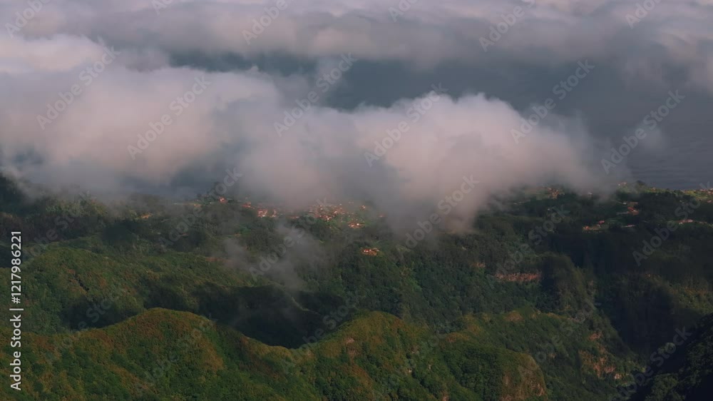 Aerial drone view of clouds moving over epic mountains peak in Madeira Island, Portugal Aerial drone view of clouds moving over epic mountains peak in Madeira Island, Portugal