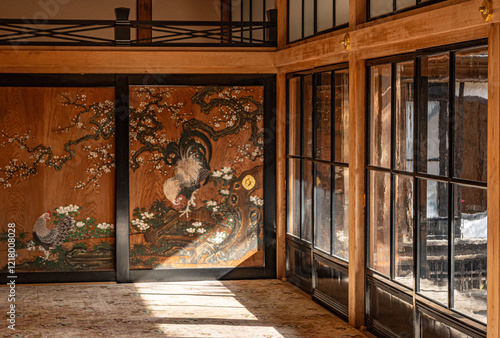 Japandi interior, a room with Japanese paintings on the wall with earthy brown tones and sunlight shining through the windows inside the Tamozawa Imperial Villa Memorial Park  Nikko Japan.