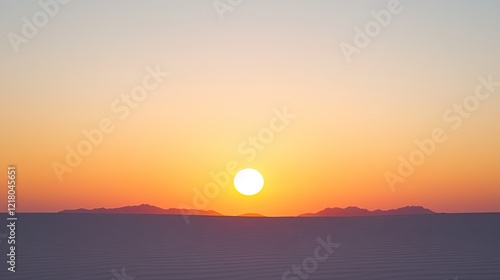 Serene sunset over a vast desert landscape with distant mountains under a clear sky