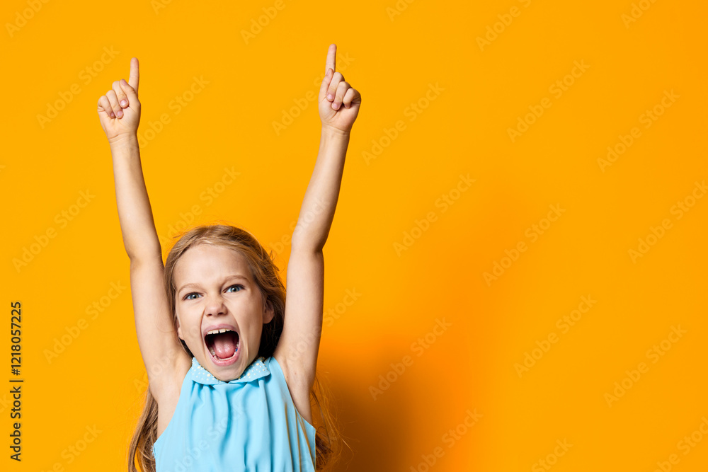 Joyful little girl with raised hands celebrating against vibrant orange background Joyful little girl with raised hands celebrating against vibrant orange background