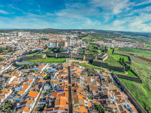 Aerial view of the castle of Estremoz in Portugal dominated by a square keep built from white marble, surrounded by four gates, bastions, ravelins and other defensive structures photo