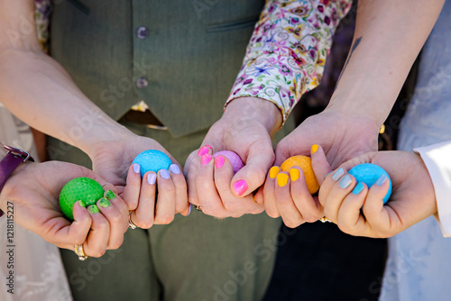 Wedding party holding coloured eggs matching their painted nails
