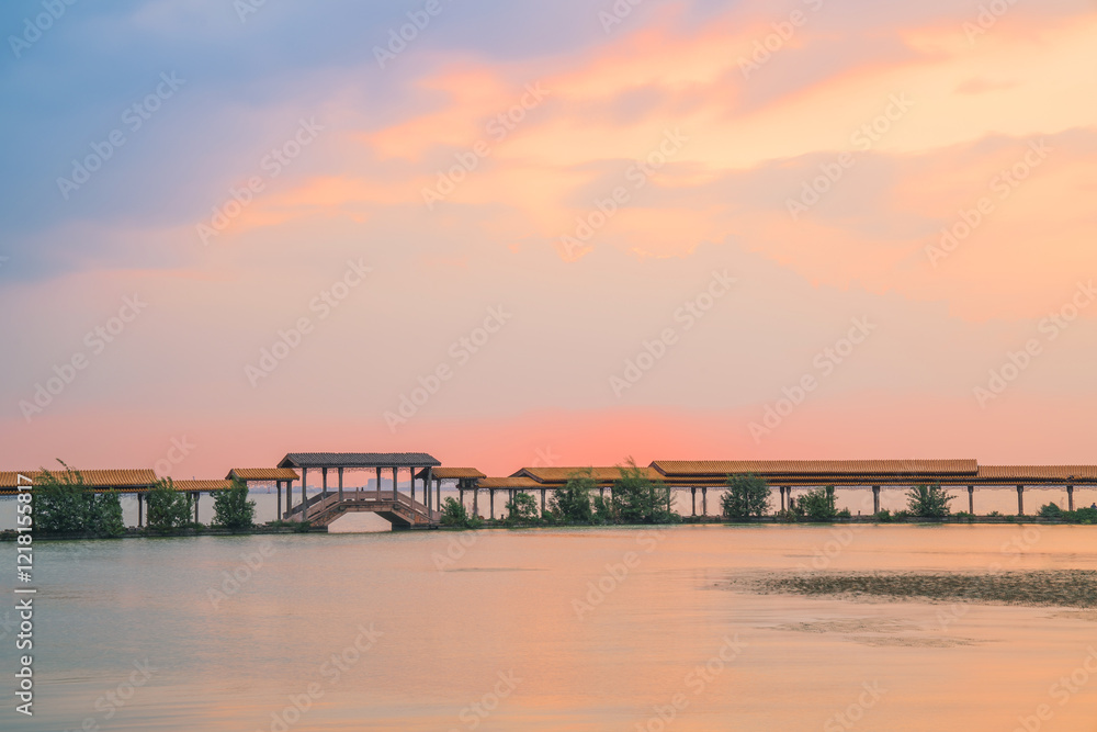An ancient building complex and sunset scenery on the Taihu Lake Lake in Wuxi, Jiangsu Province, China will be on June 3, 2024 An ancient building complex and sunset scenery on the Taihu Lake Lake in Wuxi, Jiangsu Province, China will be on June 3, 2024