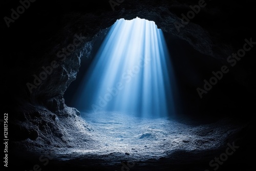 Light beams pierce the darkness of a cave, illuminating the cavern floor.