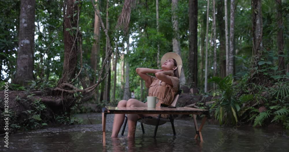 female sitting on chair relax and drinking coffee at stream in vacation, 4k video female sitting on chair relax and drinking coffee at stream in vacation, 4k video