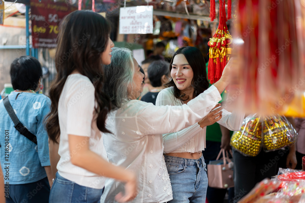 Mother and two daughter shopping for Chinese New Year decorations and ornaments Mother and two daughter shopping for Chinese New Year decorations and ornaments