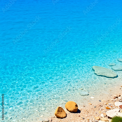 Blue crystal waters at a small beach near archaeological site of Heraion, sanctuary of goddess Hera, in Perachora, Loutraki, Greece photo