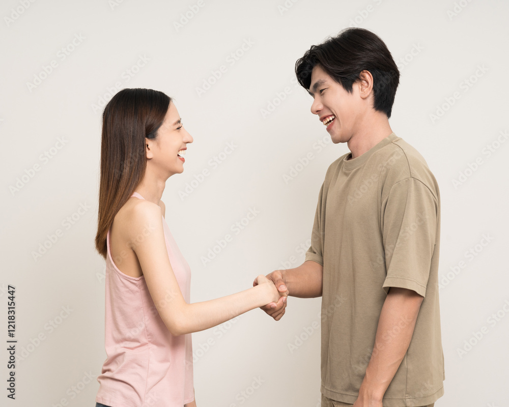 Happy asian couple attractive in various action gesture standing on isolated white background. Cheerful Smiling young man and woman hands shake Happy asian couple attractive in various action gesture standing on isolated white background. Cheerful Smiling young man and woman hands shake
