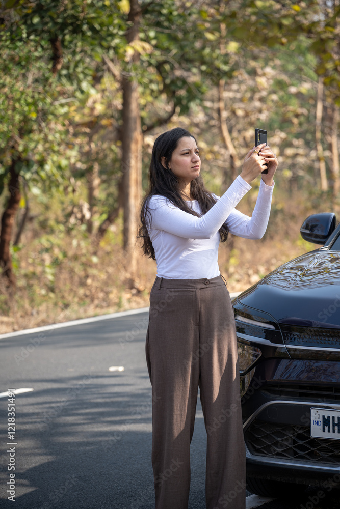 Young woman searching for a mobile network in the forest with her damaged car, bad connection and no signal concept image Young woman searching for a mobile network in the forest with her damaged car, bad connection and no signal concept image