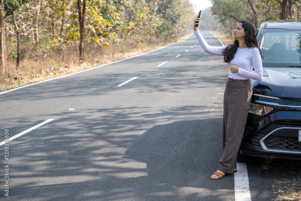 Young woman searching for a mobile network in the forest with her damaged car, bad connection and no signal concept image Young woman searching for a mobile network in the forest with her damaged car, bad connection and no signal concept image