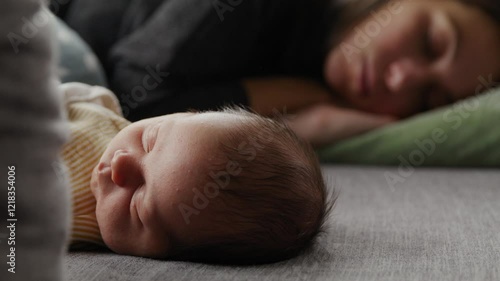 Infant baby sleeping on couch in front of mother during day - Parental sleep