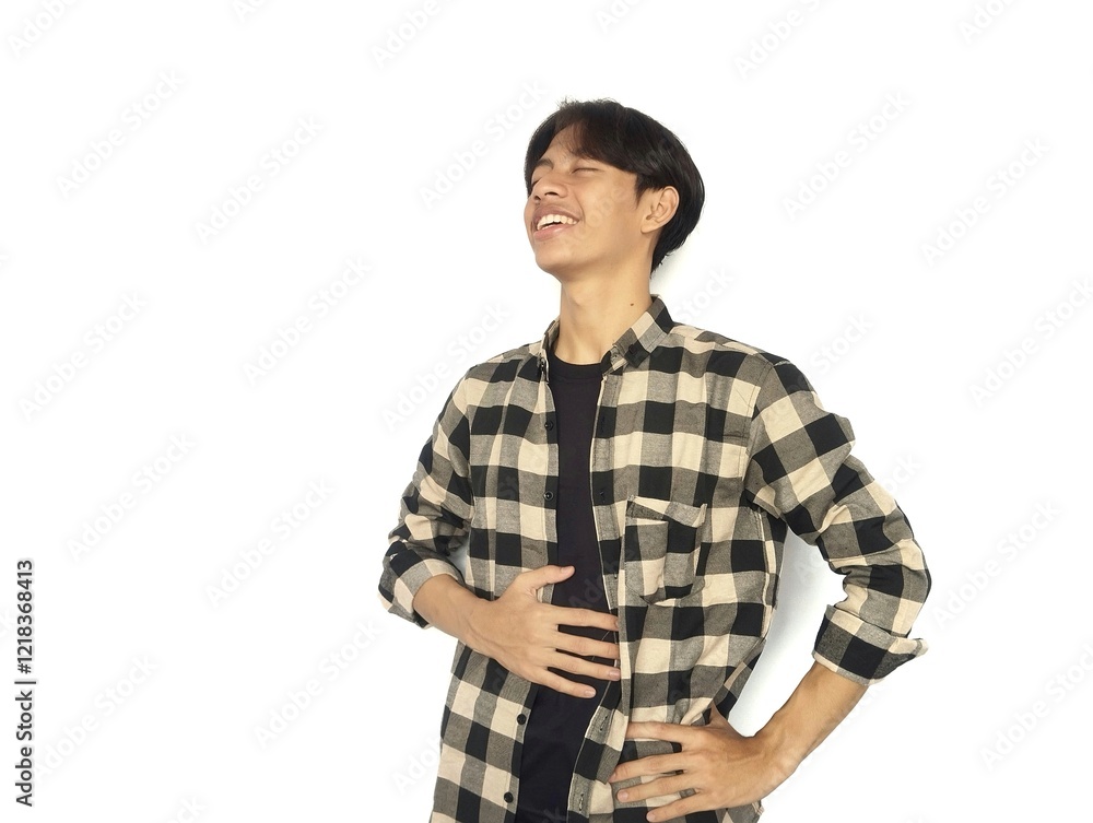 Young Asian man touches his stomach with a relieved expression, full expression after eating, satisfied gesture Young Asian man touches his stomach with a relieved expression, full expression after eating, satisfied gesture