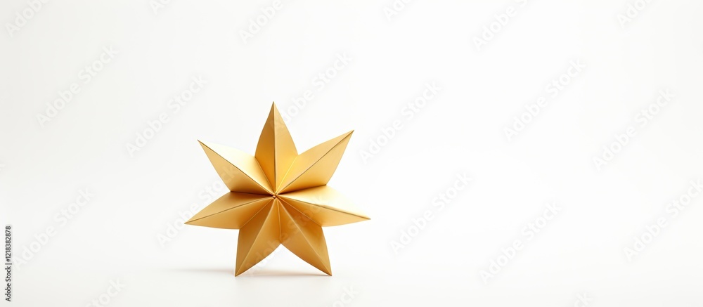 Obraz premium Golden origami star in metallic yellow positioned off-center on a clean white background highlighting shadows and shape details for a minimalist look.