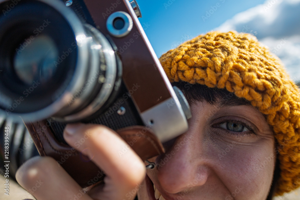 Obraz premium young girl with a camera. photographer with camera. Stylish girl with a film camera. takes a shot.