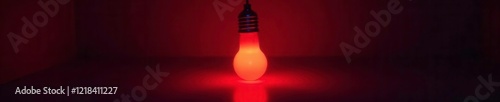 Glow of the red light bulb in a dark environment, illumination, ambient, glowin photo