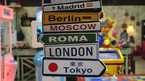 Very colorful video and original sign with different names of cities of the world