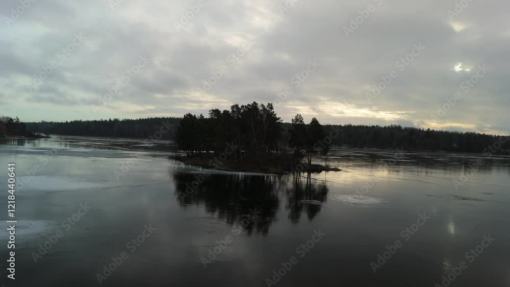 Sun rise aerial drone flying over a lake towards a small island Sun rise aerial drone flying over a lake towards a small island