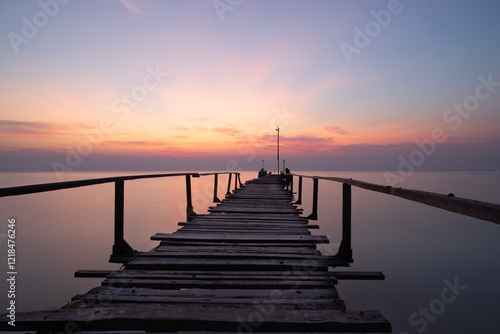 Wallpaper Mural Flat Calm.  Long exposure photograph of a wooden pier jutting out to sea at sunrise. The sea is silky smooth and the sky is orange and blue. Ao Cho, Koh Samet, Thailand. Torontodigital.ca