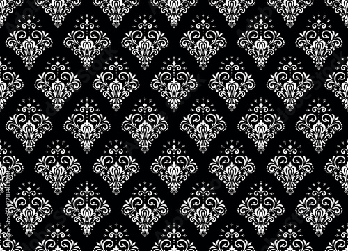 Wallpaper in the style of Baroque. Seamless vector background. White and black floral ornament. Graphic pattern for fabric, wallpaper, packaging. Ornate Damask flower ornament.