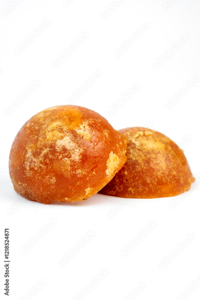 Juicy and rich natural jaggery blocks displayed on a white backdrop showcasing their texture and color. Juicy and rich natural jaggery blocks displayed on a white backdrop showcasing their texture and color.