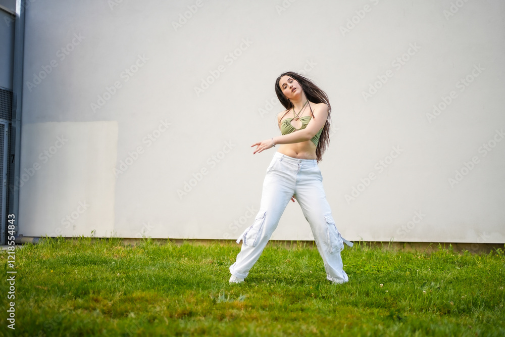 Woman dancing urban music in the campus Woman dancing urban music in the campus
