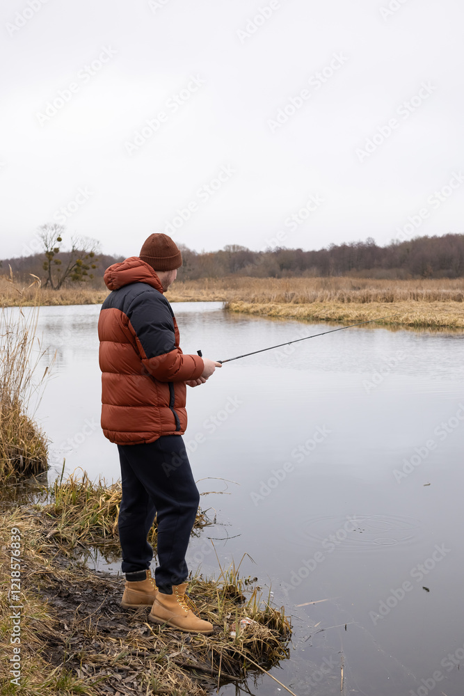 Fly fisherman catching fish in the river Fly fisherman catching fish in the river