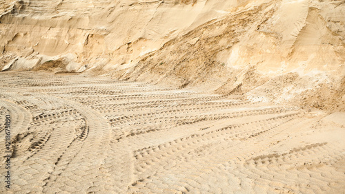 Excavator wheel marks in a sand quarry