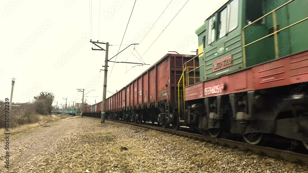 The train with freight cars travels by rail. Many wagons go into the distance, a long shot. The train with freight cars travels by rail. Many wagons go into the distance, a long shot.