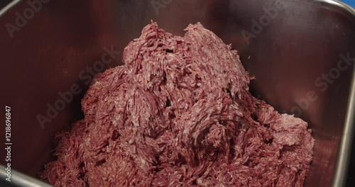 Minced meat in a stainless steel container. Meat processing plant concept. photo