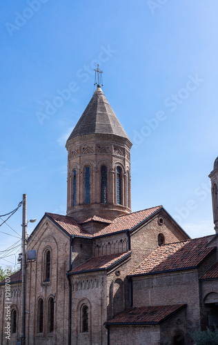 Historic brick church with a pointed dome and red-tiled roofs in Tbilisi, Georgia, 14 September, 2024 photo