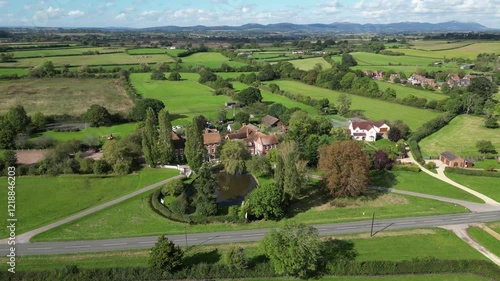 luxury property castle estate hotel surrounded by green fields england sunshine enhances real mansion circling aerial view drone uk scenic architecture historical tourism travel  photo