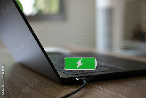 Laptop with charging conector with fully chargine battery icon