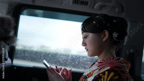 Wallpaper Mural Young women in their 20s wear traditional hakama (kimono) in Japan, known for the graduation ceremony. She operates a smartphone while moving in the car Torontodigital.ca