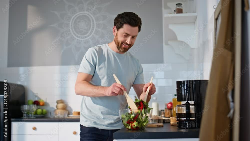 Carefree guy mixing salad home kitchen closeup. Positive man cooking breakfast Carefree guy mixing salad home kitchen closeup. Positive man cooking breakfast
