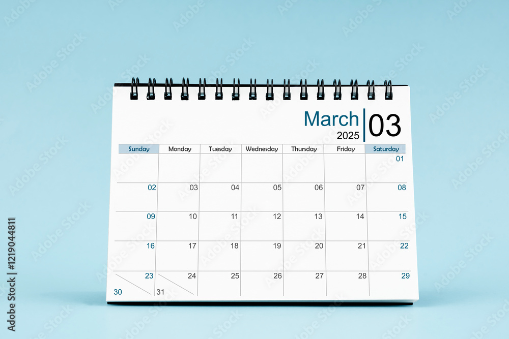 March 2025 Monthly desk calendar for 2025 year on soft blue background. March 2025 Monthly desk calendar for 2025 year on soft blue background.