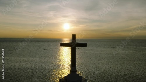 Panorama view of cross over the sea with sunrise background. Sunken Cemetery in Camiguin Island. Philippines. photo