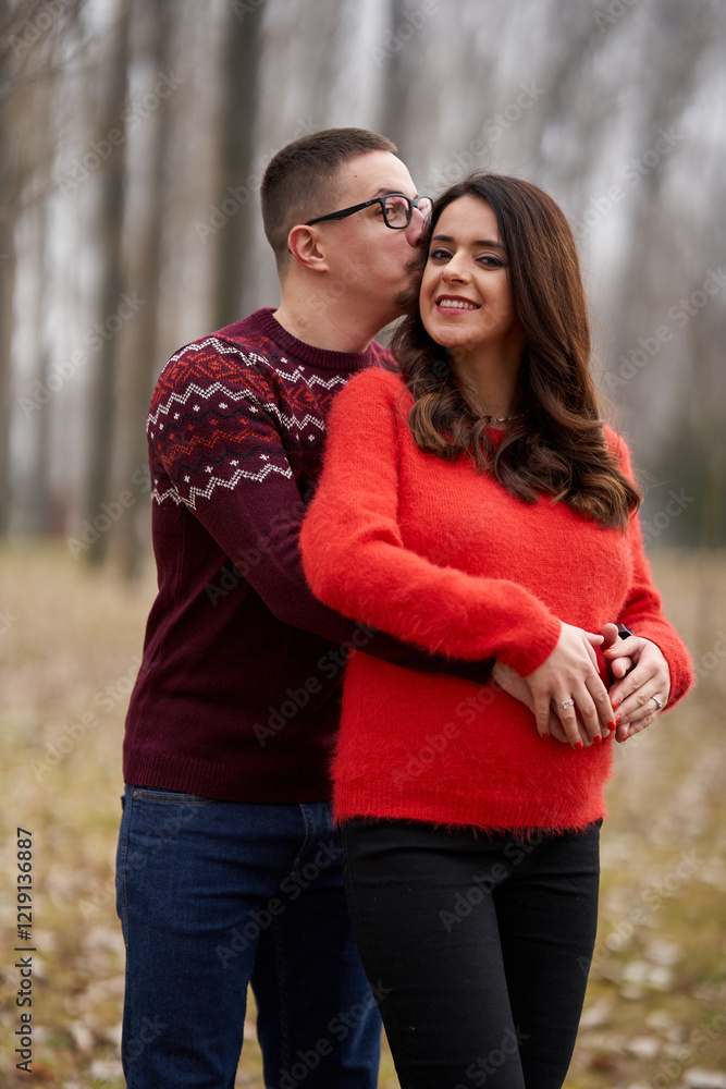 Fototapeta premium Expecting couple in nature with blurred background