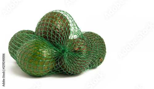 Avocados, tropical green fruit in mesh bag on white background.
