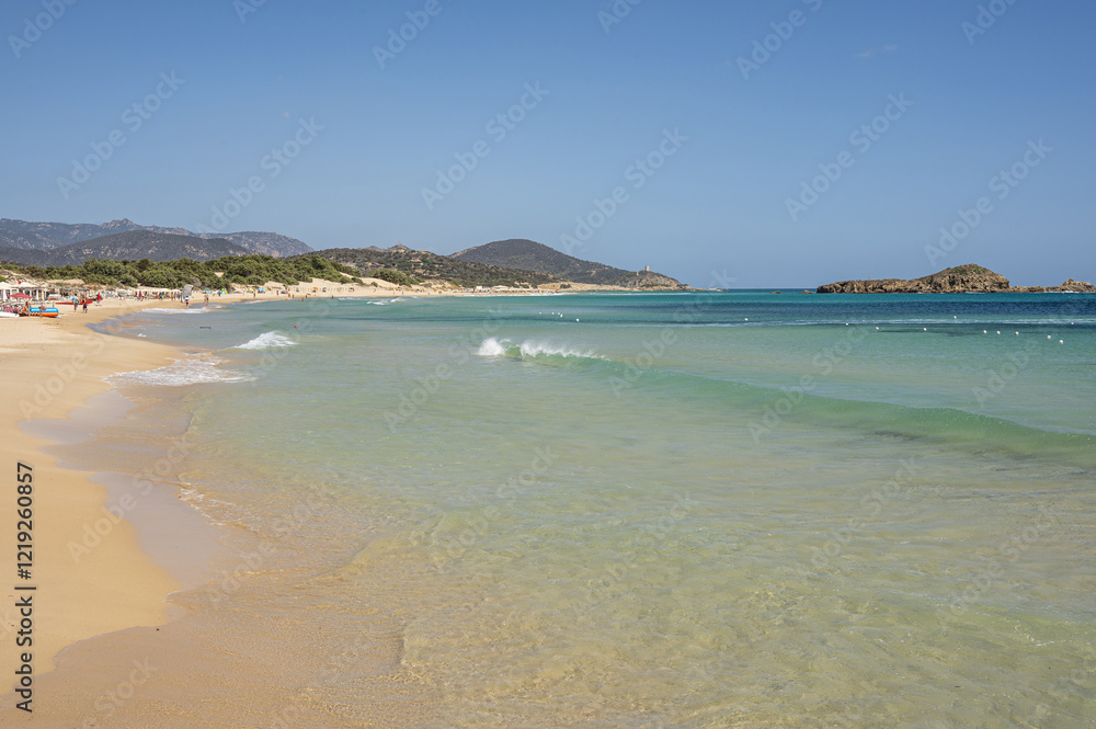 The beautiful beach of Su Giudeu in the south of Sardinia with transparent and turquoise water and a small island in front of the bay