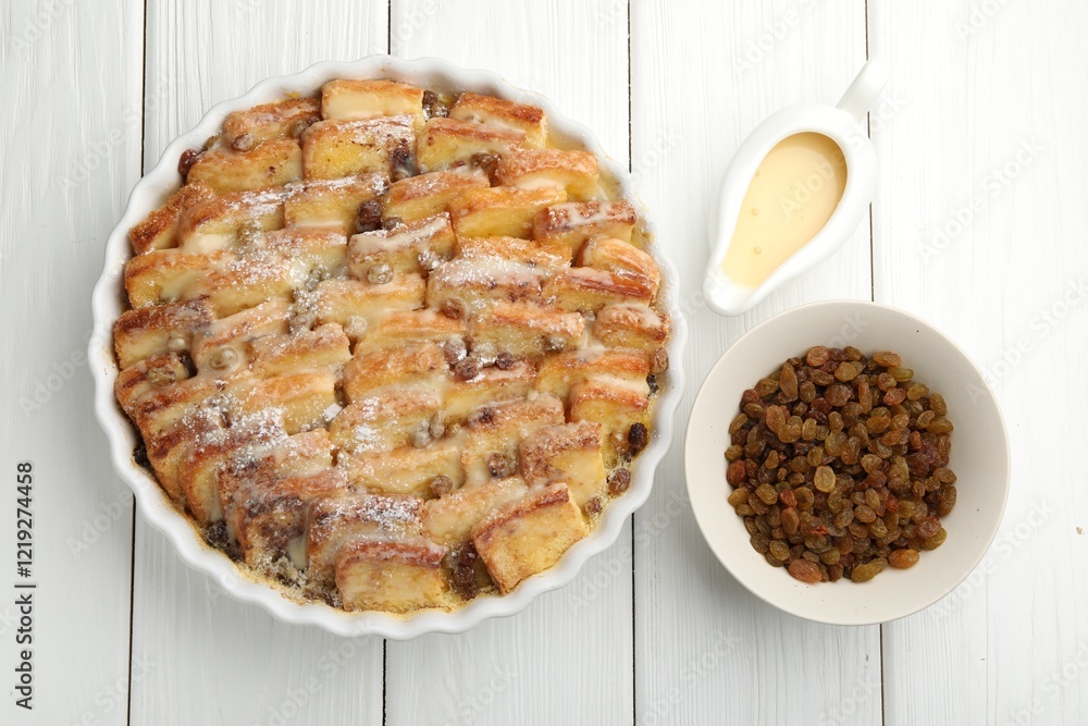 Delicious bread pudding with raisins, powdered sugar, condensed milk on white wooden table, flat lay Delicious bread pudding with raisins, powdered sugar, condensed milk on white wooden table, flat lay