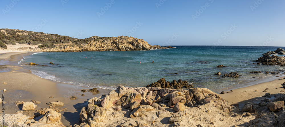 The beautiful beach of Su Giudeu in the south of Sardinia with transparent and turquoise water and a small island in front of the bay