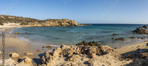 Obraz na płótnie The beautiful beach of Su Giudeu in the south of Sardinia with transparent and turquoise water and a small island in front of the bay w salonie