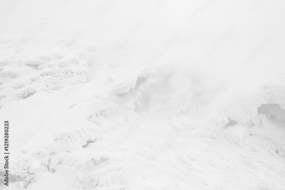 A blizzard covering a mountain pass, with snowdrifts burying the road and limiting visibility. A blizzard covering a mountain pass, with snowdrifts burying the road and limiting visibility.