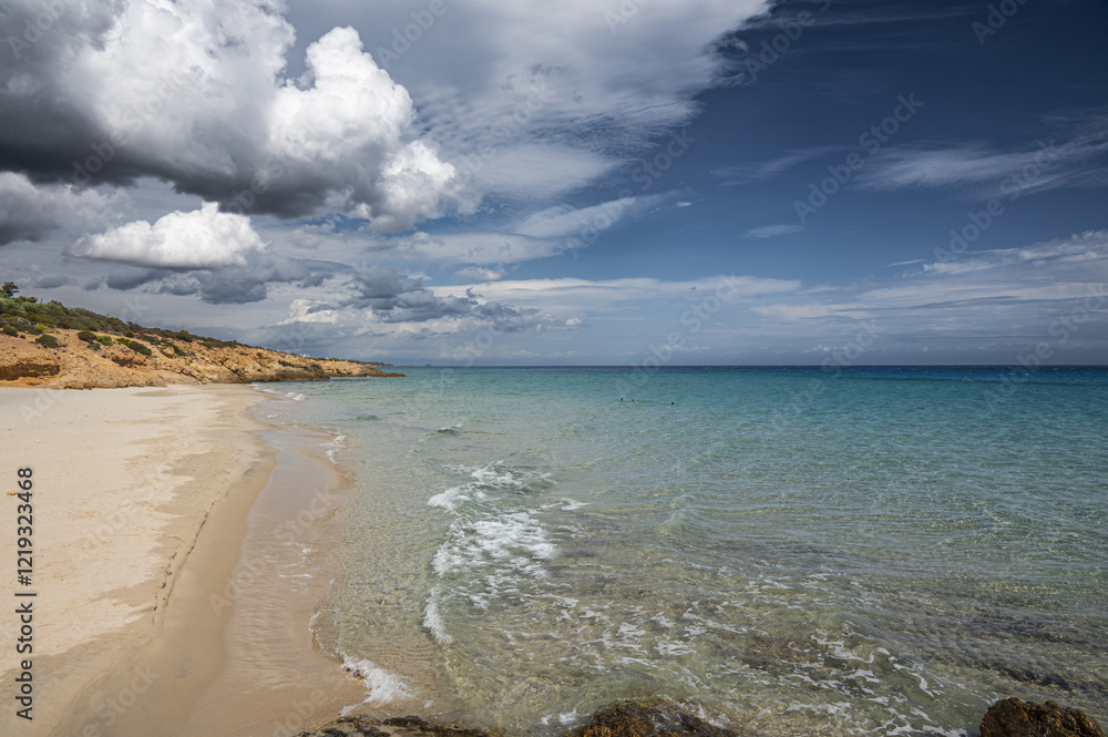 The beautiful beach of Pinus with fine sand and blue and turquoise water and storm clouds on the horizon
